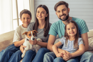 Family of 4 and dog smiling