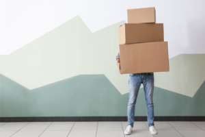 Guy standing with moving boxes