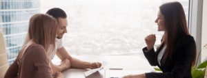 Professional and couple reviewing documents